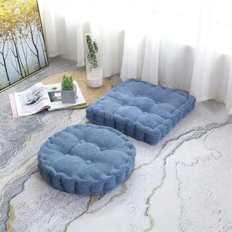 blue floor cushion and tufted cushion